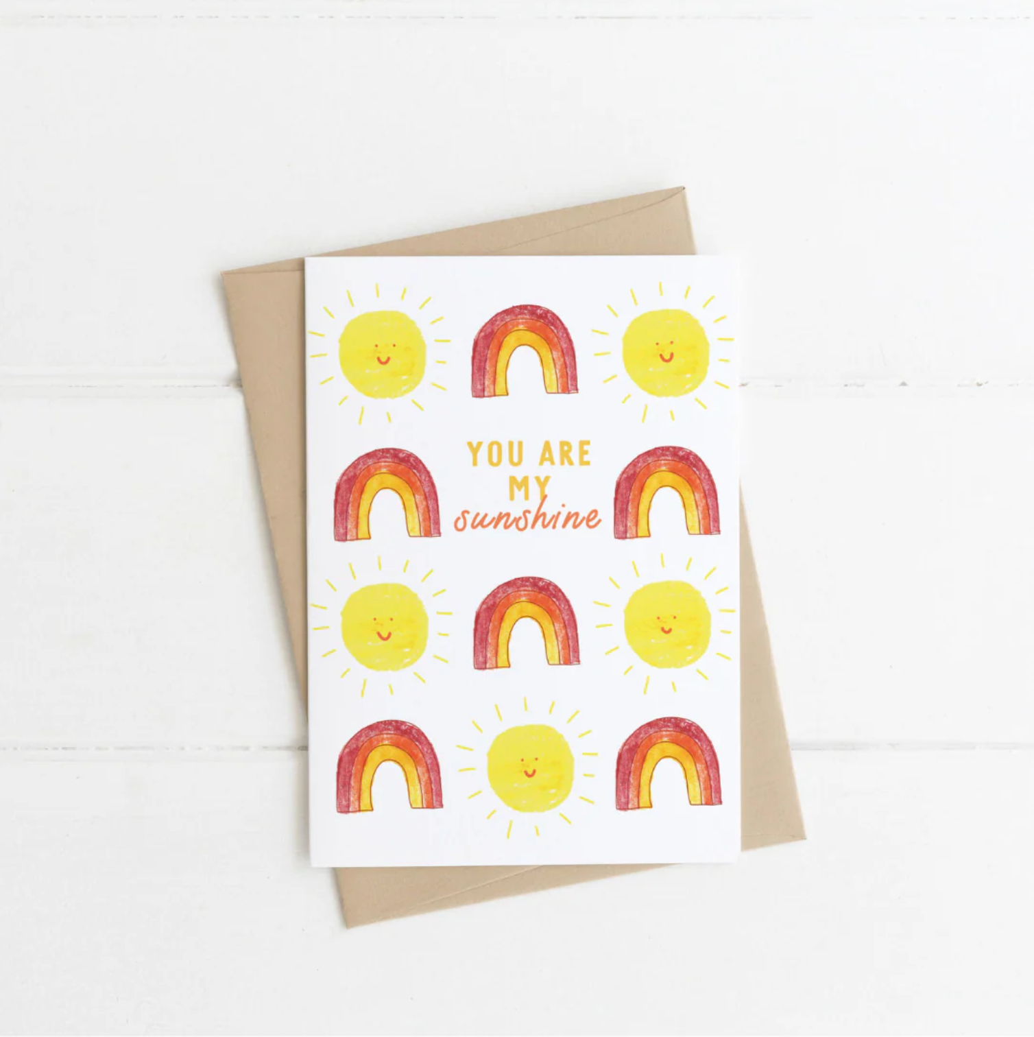 Greeting card with rainbow and sun design on a white background