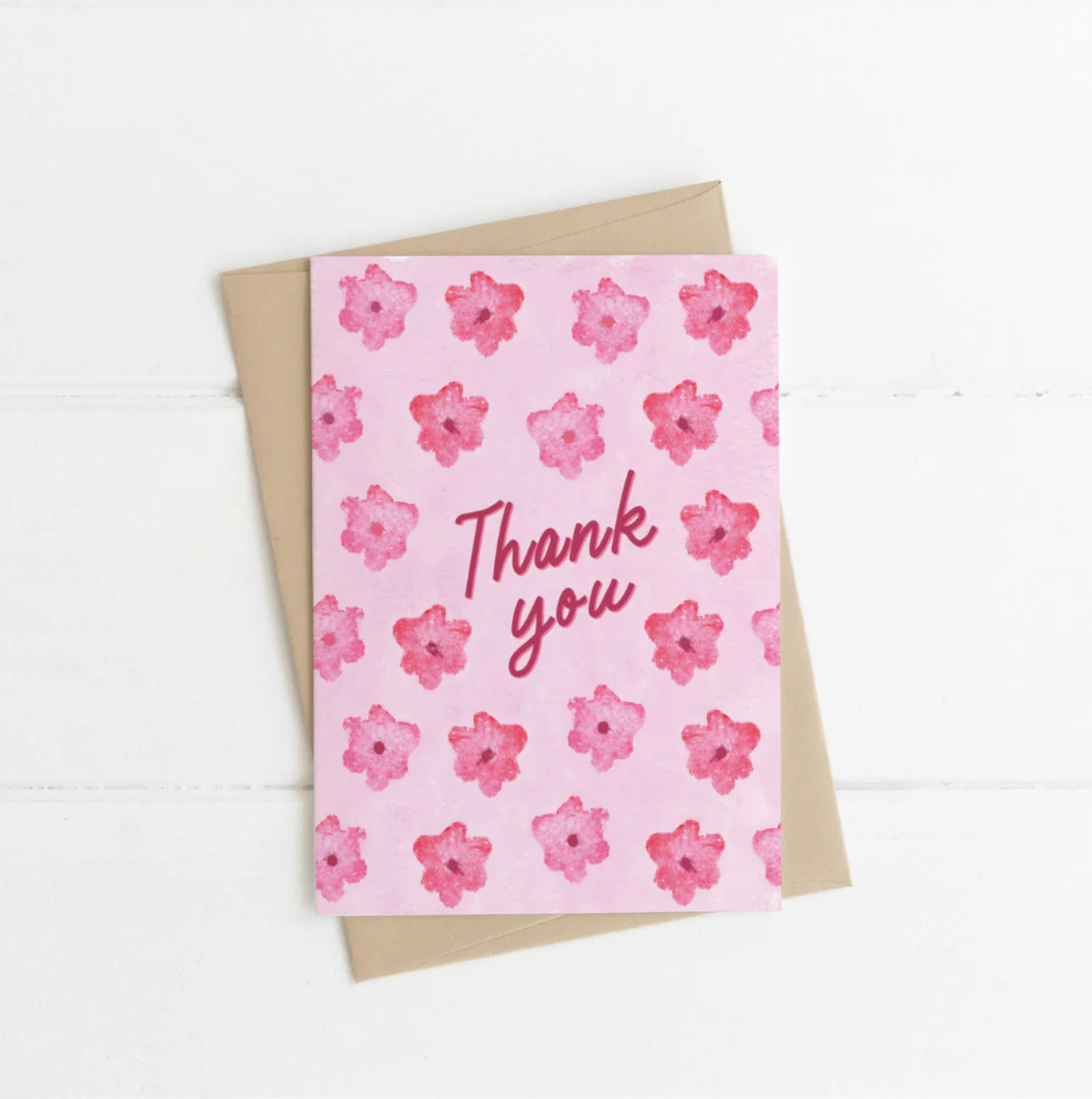 Greeting card with pink floral pattern and 'Thank you' text on a white background