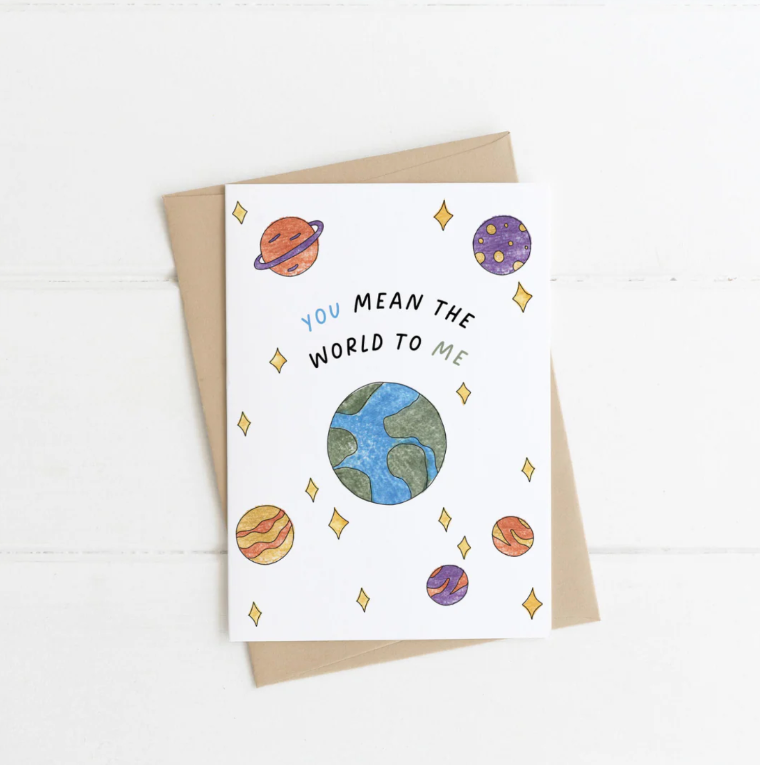 Greeting card with space-themed illustrations and 'You Mean the World to Me' text on a white background.